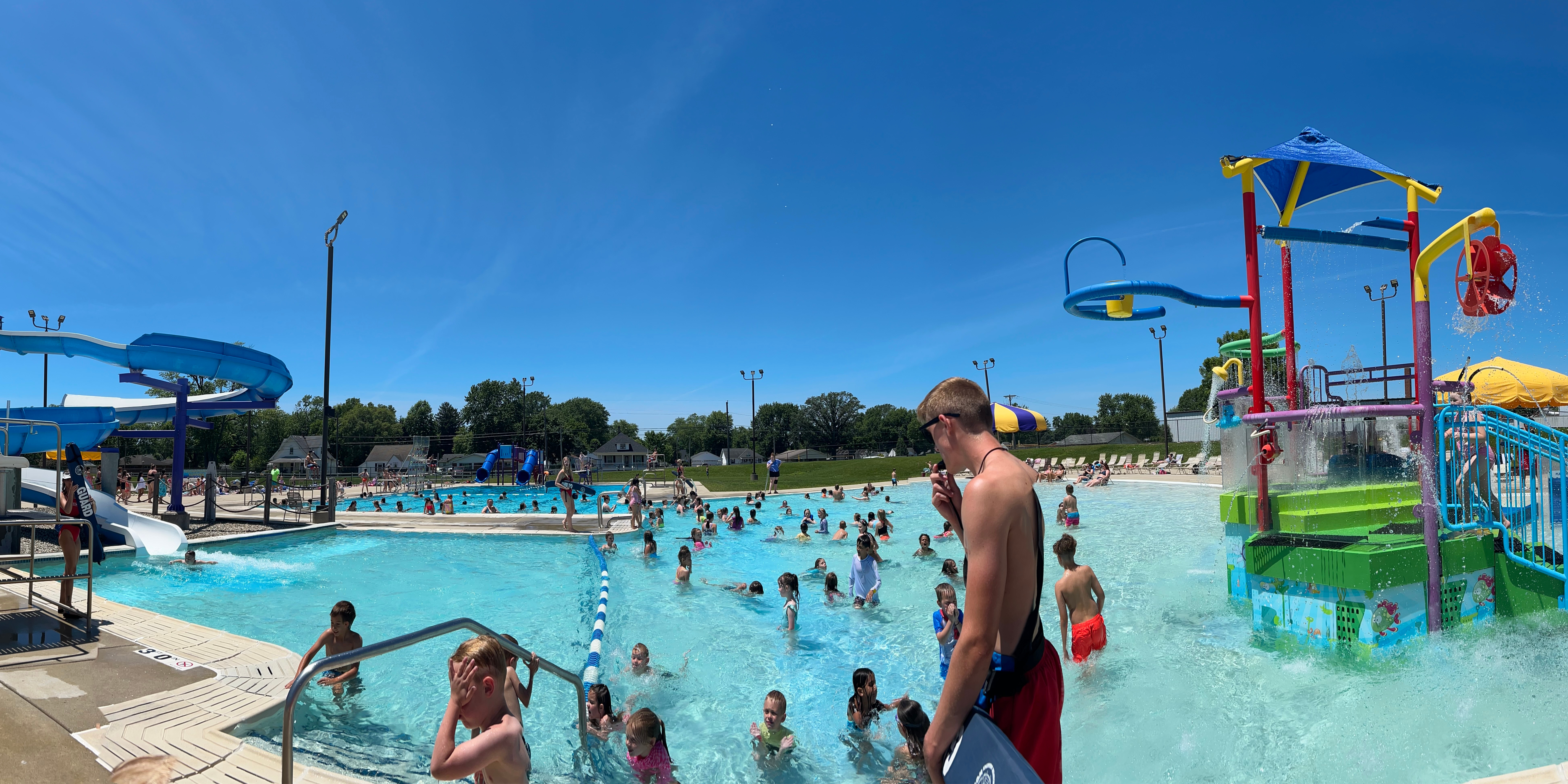 picture of lifeguard with pool in background on sunny day